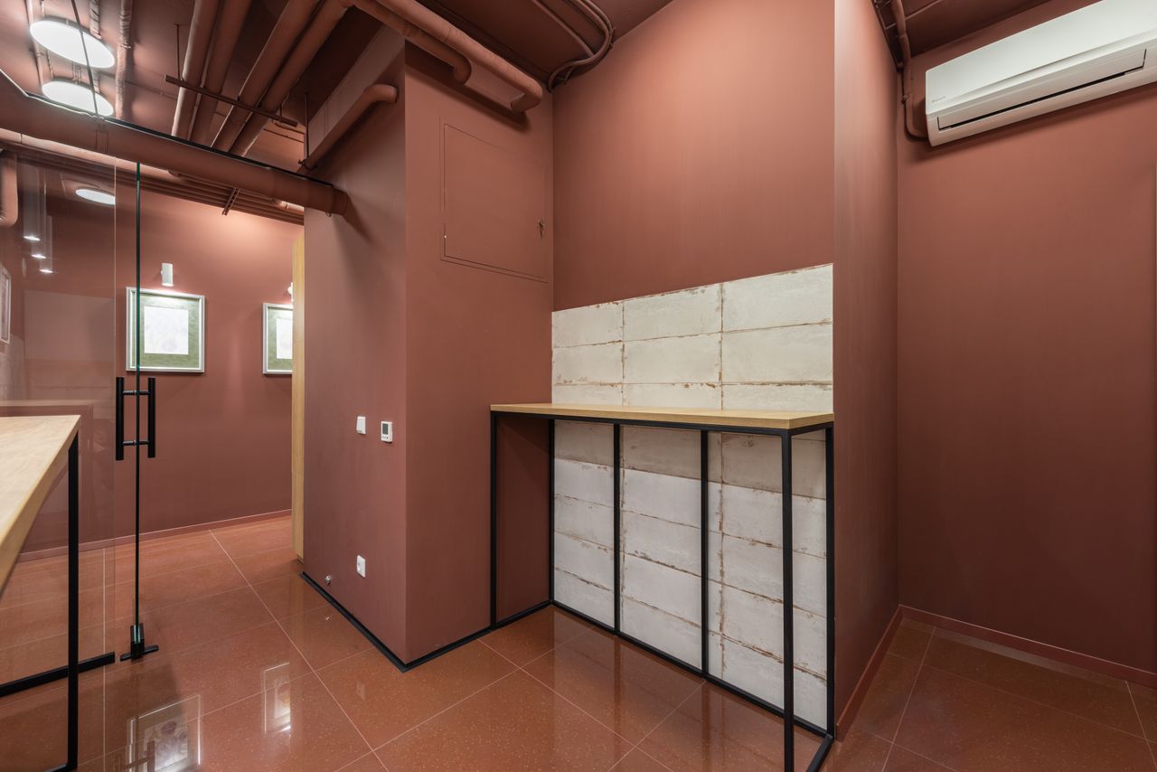about-us-02 A sleek modern office with a minimalist design focusing on earthy tones and natural light.